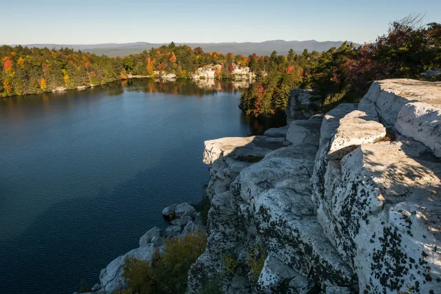 Lake Minnewaska held in white cliffs and pine, seen from the trail above