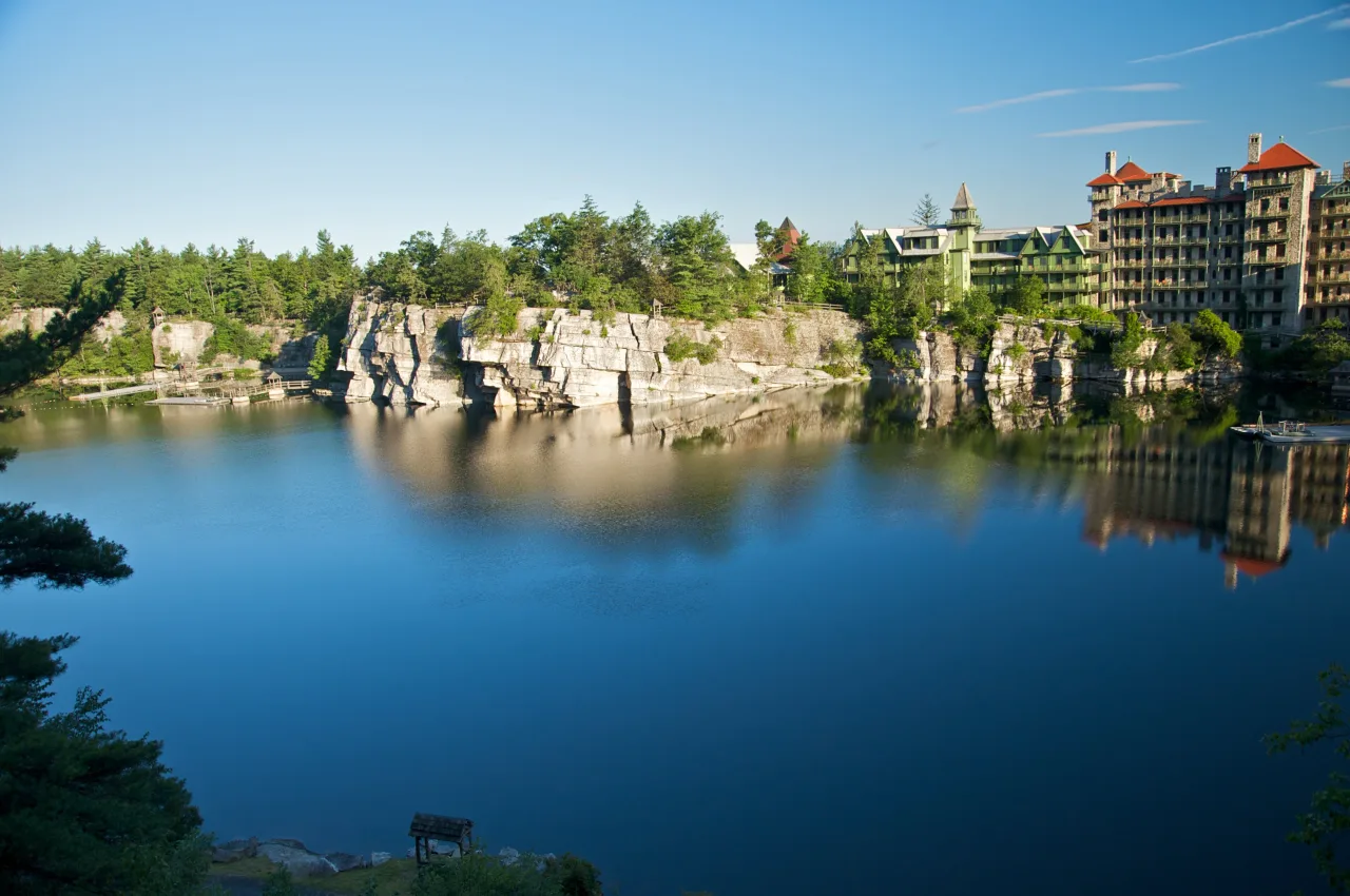 Quartz cliffs rising from the still blue water of Lake Mohonk